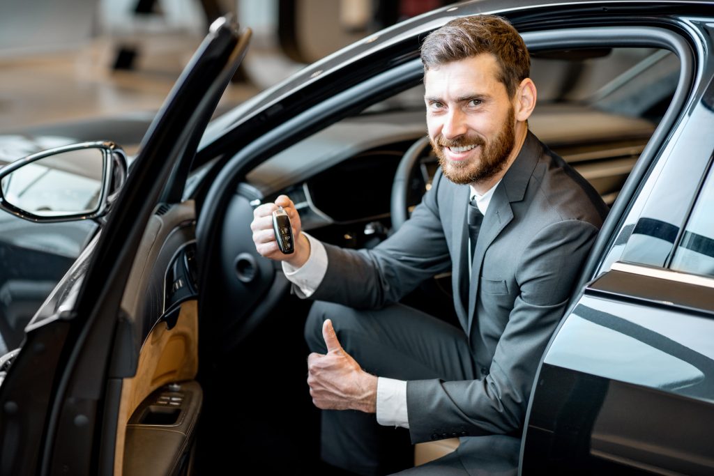 man in luxury cars about to go on road trip